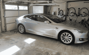 Tesla at Home next to home charger.